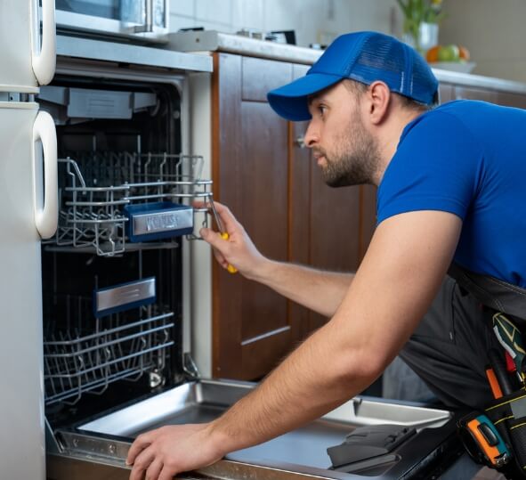 Man inspecting a dishwasher